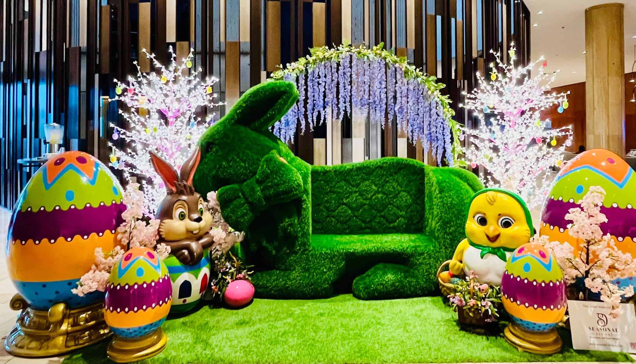 Easter commercial display featuring turf bench and fiberglass statues.